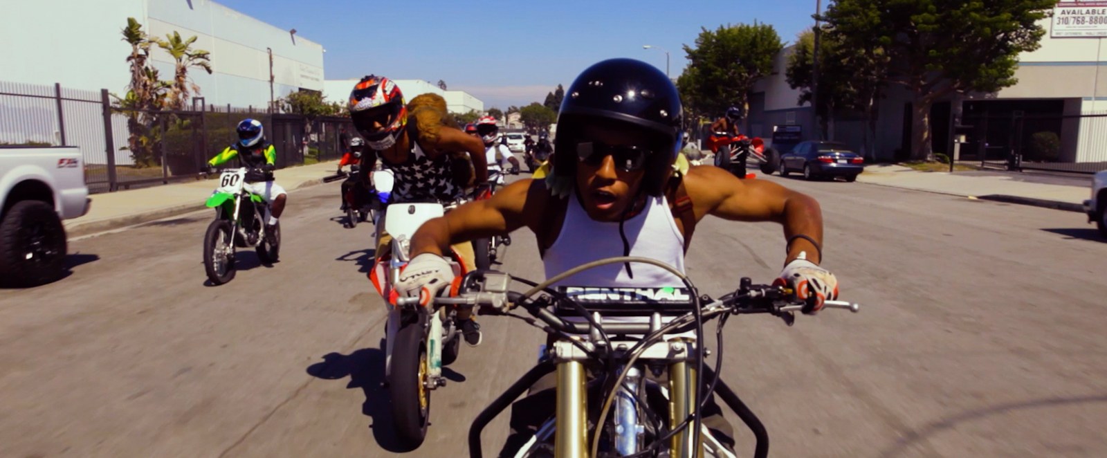 Riders on dirt bikes in the street