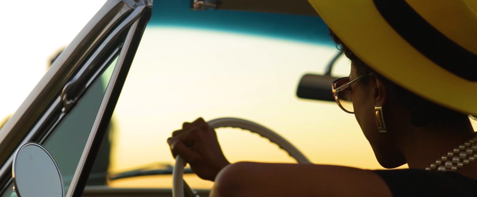 Driving in a yellow hat at golden hour