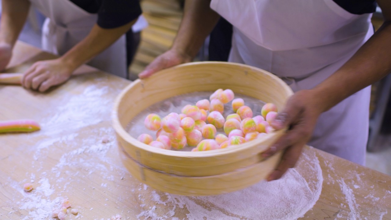 Steamer of fresh pink and green mochi
